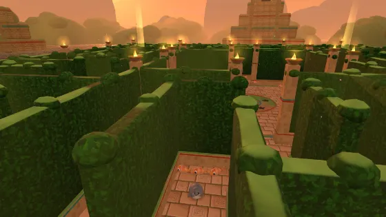 Galumph in a torch-lit maze of hedges and carved stone at sunset, with pyramids on the horizon.